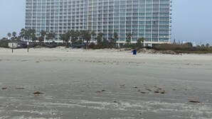 A large, multi-story hotel with a modern design, featuring a flat roof and numerous windows.