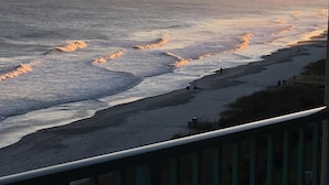 A coastal view with waves, a sandy beach, and a wooden fence. - A SLICE OF PARADISE! - Direct Oceanfront condo (Myrtle Beach)