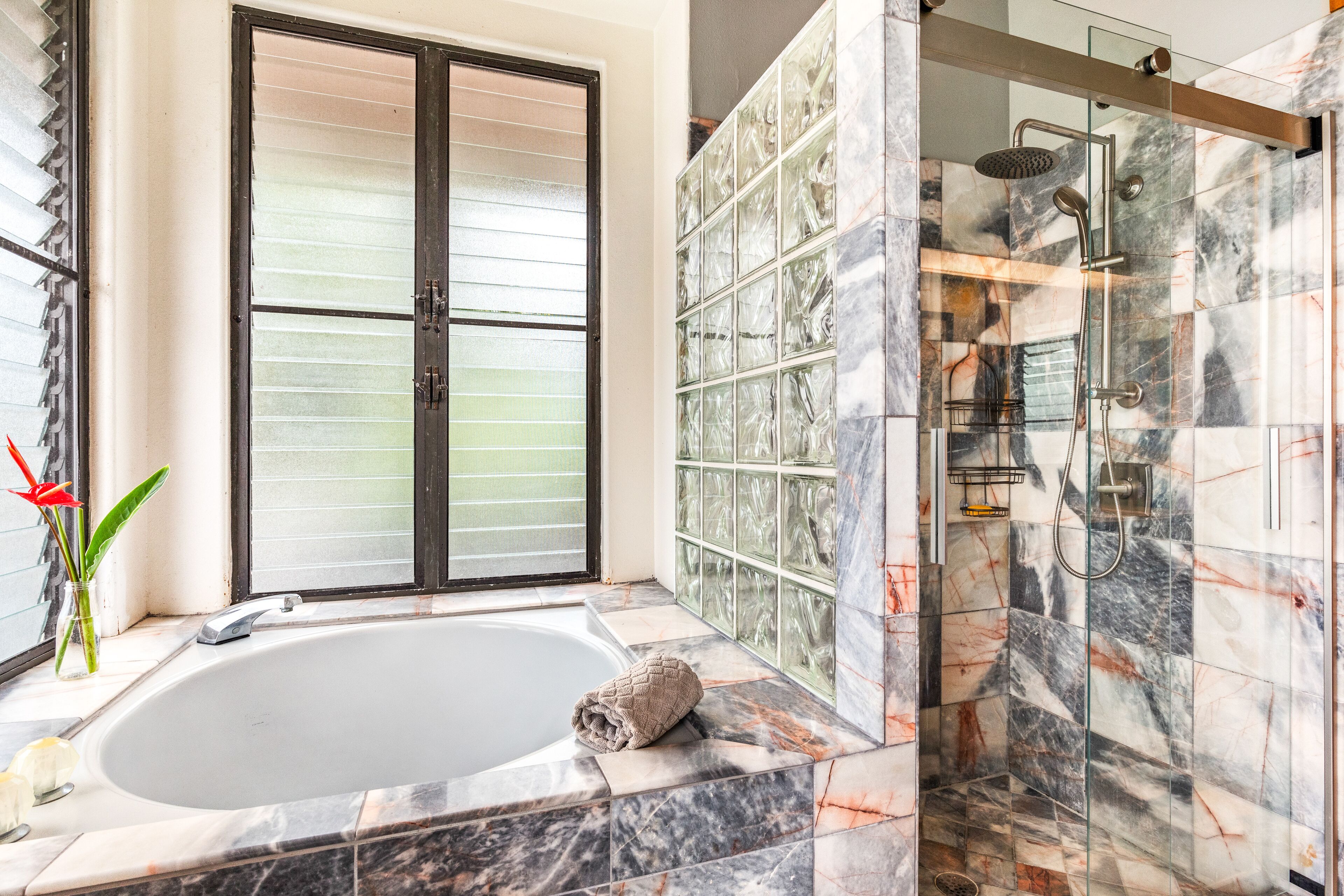 Bathtub, hair dryer, towels, toilet paper