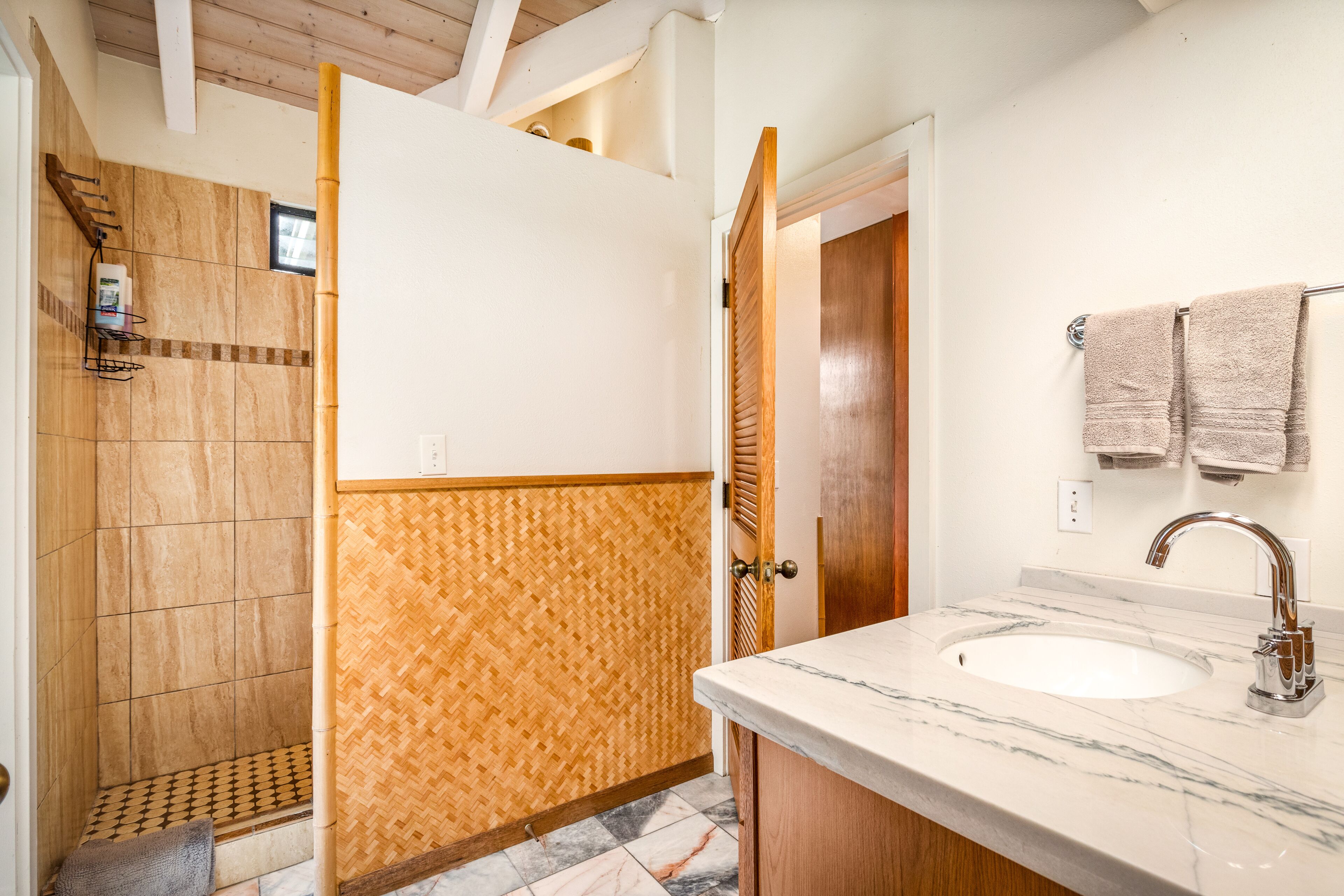 Bathtub, hair dryer, towels, toilet paper