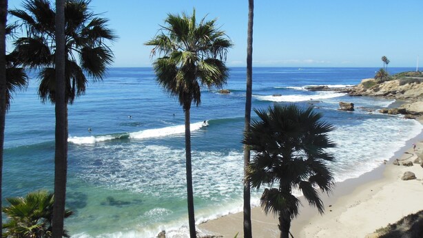 A beach with clear blue water, palm trees, and rocky cliffs. -  Laguna Home at Shaw's Cove, Ocean View, Quiet street, Short walk to beaches



 (Laguna Beach)