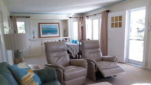 A living room with a sofa, two recliner chairs, a coffee table, and a dining area in the background. -  Laguna Home at Shaw's Cove, Ocean View, Quiet street, Short walk to beaches



 (Laguna Beach)