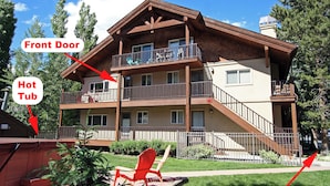 A multi-story building with a front door and a hot tub.