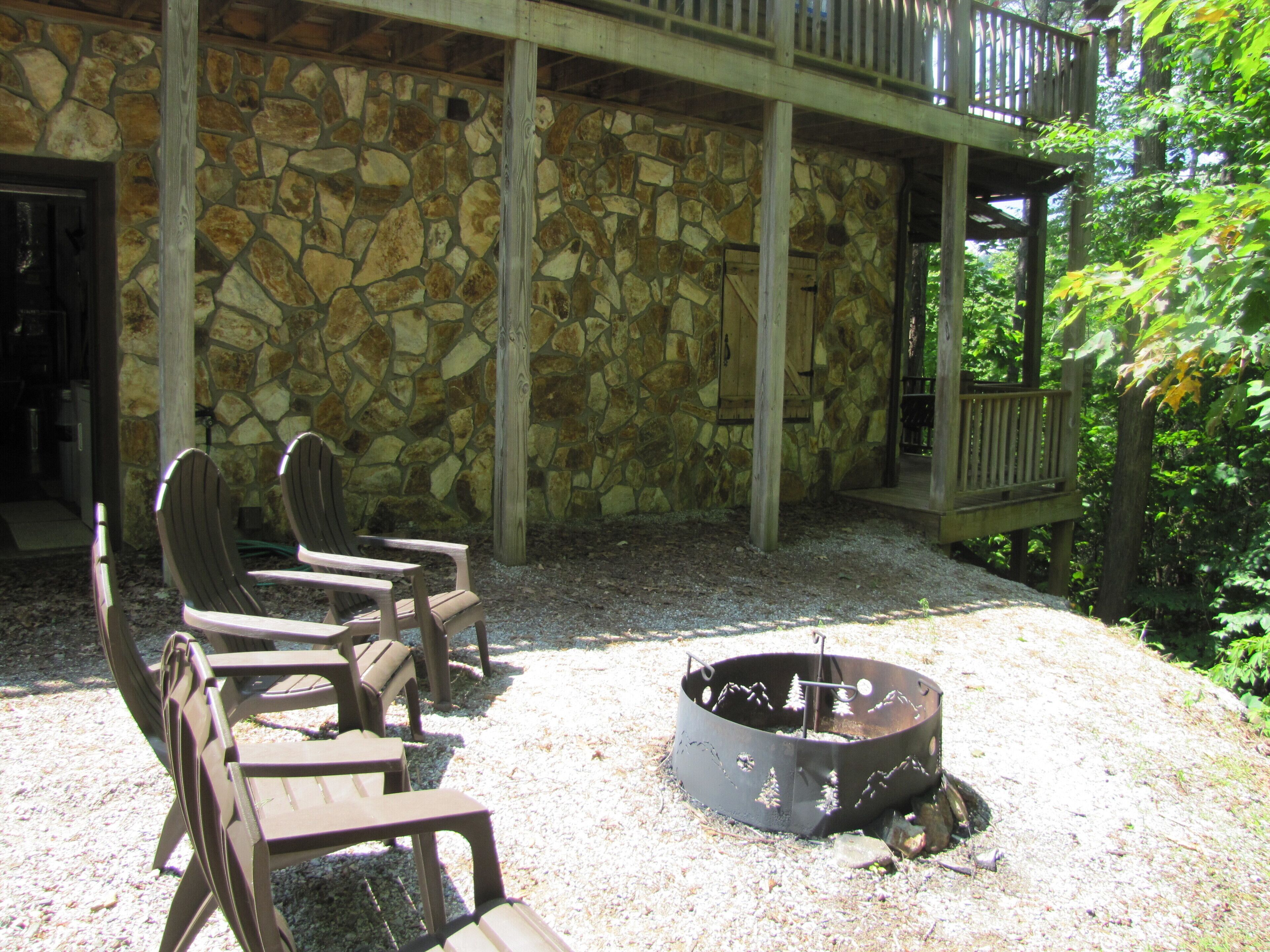A stone wall with a fire pit and outdoor seating.