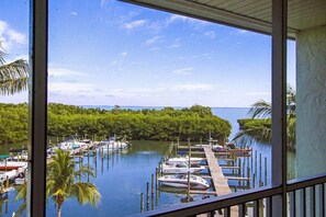 A marina with boats docked, surrounded by lush greenery and a clear sky. - Penthouse - Bay Front - 2 Story - Sleeps 8 at South Seas Island Resort, Captiva (Captiva)