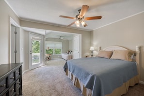 A bedroom with a bed, a ceiling fan, a dresser, and a door leading to a balcony. - Fabulous views on nice cove! Easy short walk to dock. Outdoor kitchen & fire pit (Gainesville)