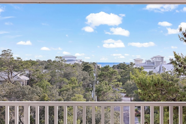 The living room flows out to a large balcony with Gulf of Mexico views.