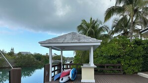 A wooden dock with a gazebo, a paddleboard, and a fishing rod. - Luxurious 'Old Fort Bay' Large SINGLE LEVEL with 4 bedrooms each with an ensuite (Old Fort Bay)