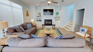 A living room with a sofa set, a coffee table, a TV, and a fireplace. - All Decked Out w/ private pool, Free Golf, Zipline (Destin)