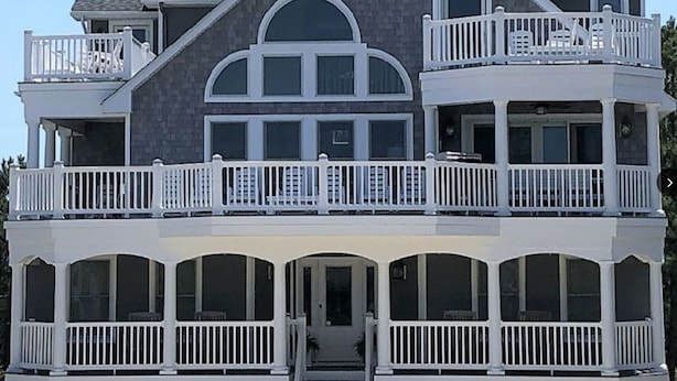 A two-story building with multiple balconies and large windows. - 5-Star Oceanblock Sleeps 18! Luxury Beach Vacation Home Private Beach Community  (Bethany Beach)