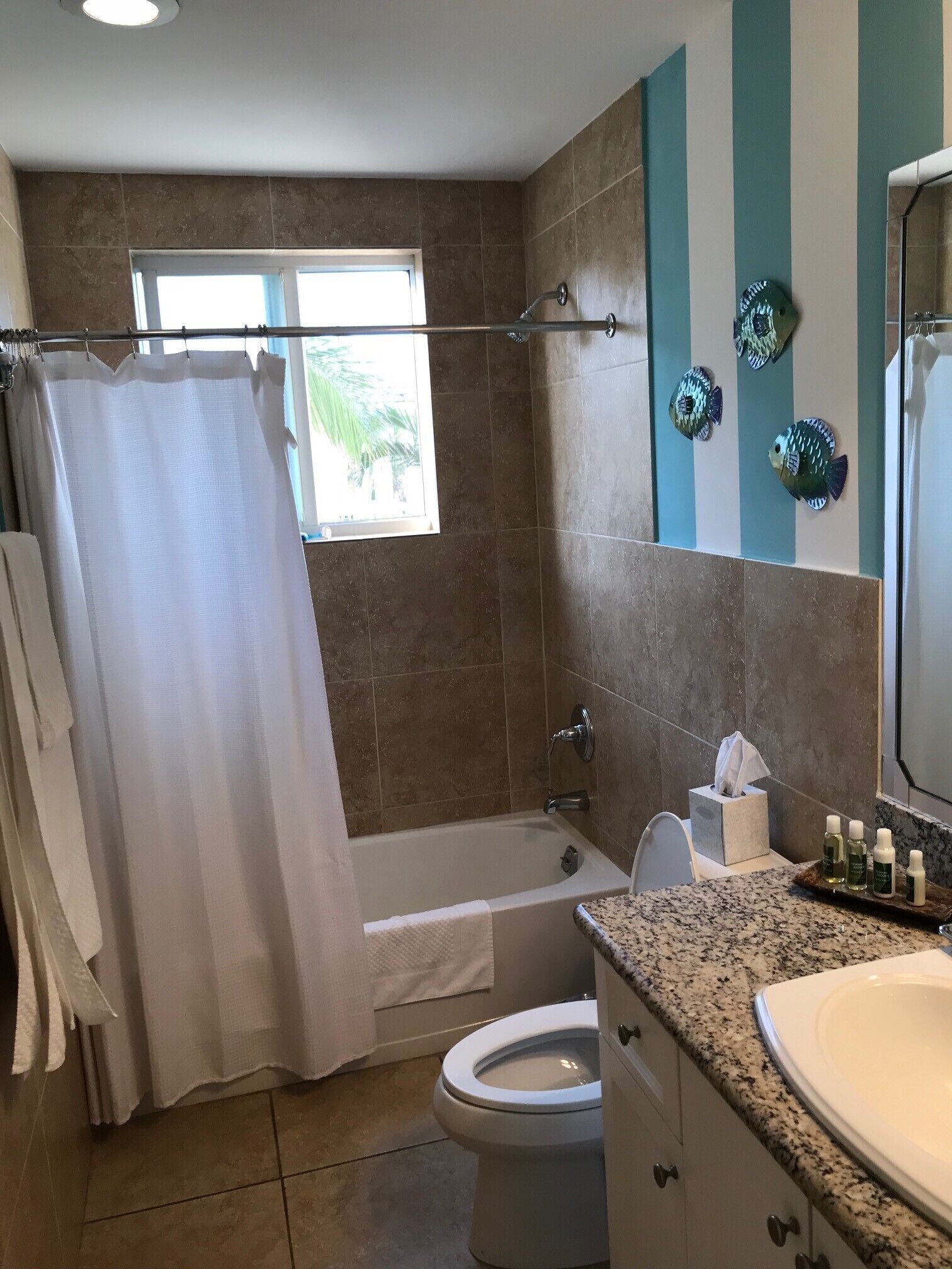 A bathroom with a bathtub, toilet, and sink.