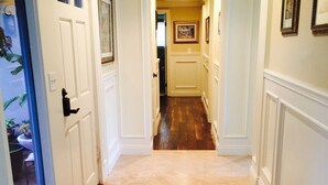 A hallway with a tiled floor and white walls, leading to a door marked "Exit". - VACATION HOME HAVE POOL & SPA / NEAR TO BEACHES-DISNEYLAND. (Huntington Beach)