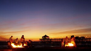 A beach scene at dusk with a wooden pier and a gazebo in the background. - VACATION HOME HAVE POOL & SPA / NEAR TO BEACHES-DISNEYLAND. (Huntington Beach)