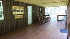 A wooden cabin with a porch, a welcome sign, and a sign reading "Camp Critter". - Rustic and all the comforts of home in the Heart of the Elk Range (Benezette)