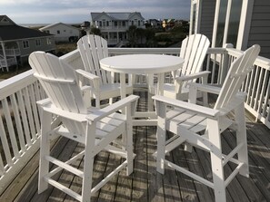 A white wooden deck with a round table and four Adirondack chairs. - Oceanfront /Spectacular Views/"OCEAN BEACH " (Bald Head Island)