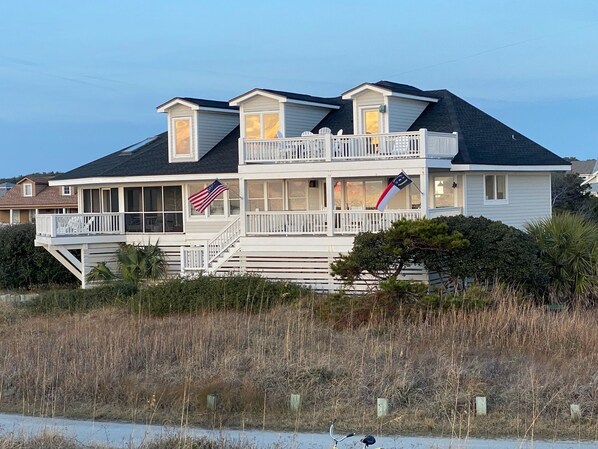 A two-story house with a balcony, a deck, and a flag. - Oceanfront /Spectacular Views/"OCEAN BEACH " (Bald Head Island)