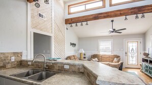 A kitchen with a granite countertop, double sink, and a ceiling fan. - Book now for Fall 2026! Pet friendly! (Gulf Shores)
