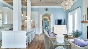 A spacious living area with a sofa, a coffee table, and a television.