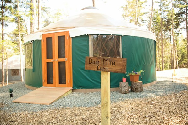 A yurt with a wooden door and a ramp leading to the entrance. - Yurt Glamping on the Quiet-side of Acadia National Park! (Southwest Harbor)