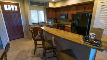 A kitchen with wooden cabinets, a granite countertop, and a built-in stove.