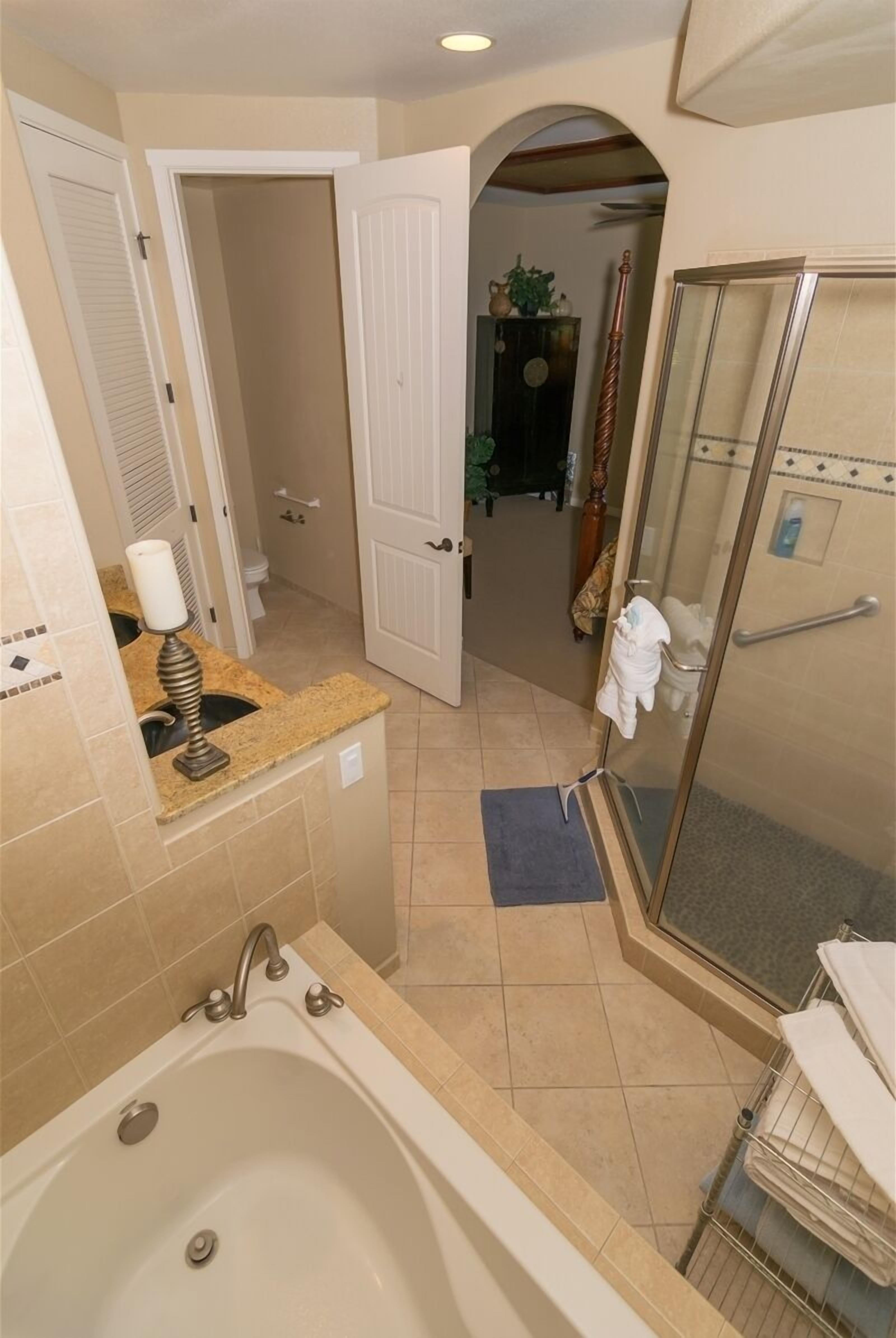 Bathtub, hair dryer, towels, shampoo