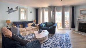 A living room with a sofa, armchairs, a coffee table, and a fireplace. - Adorable 3 bedroom 2.5 Escape - bike to beach (Rehoboth Beach)