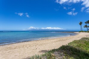 Enjoy a serene beach experience with calm ocean waters and a sandy shoreline.