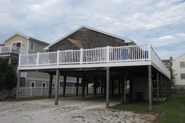 Front of house with spacious deck.