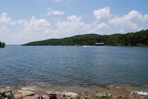 A calm lake with a small island and a boat dock. - NO STAIRS•Next to SDC & Table Rock Lake•King Master• 2beds 2baths•20ft Patio (Branson)