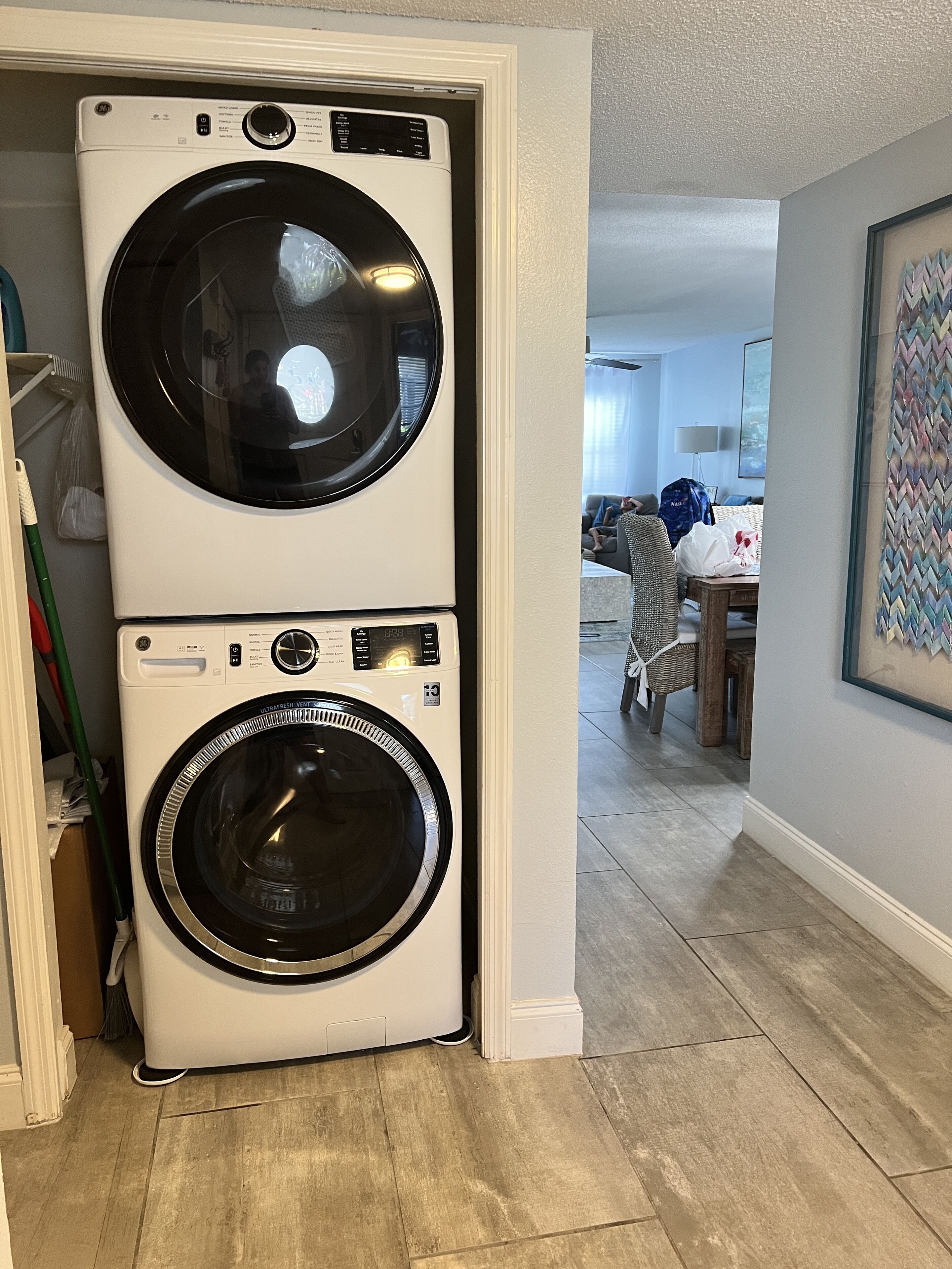 A laundry room with two stacked front-loading washing machines.