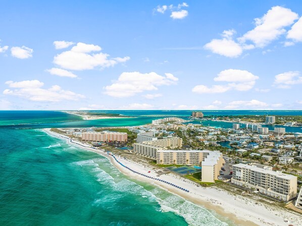 A coastal resort area with beachfront hotels, a marina, and a clear view of the ocean. - Beach Front, Corner Unit Condominium on the 6th Floor. Incredible Beach View! (Destin)