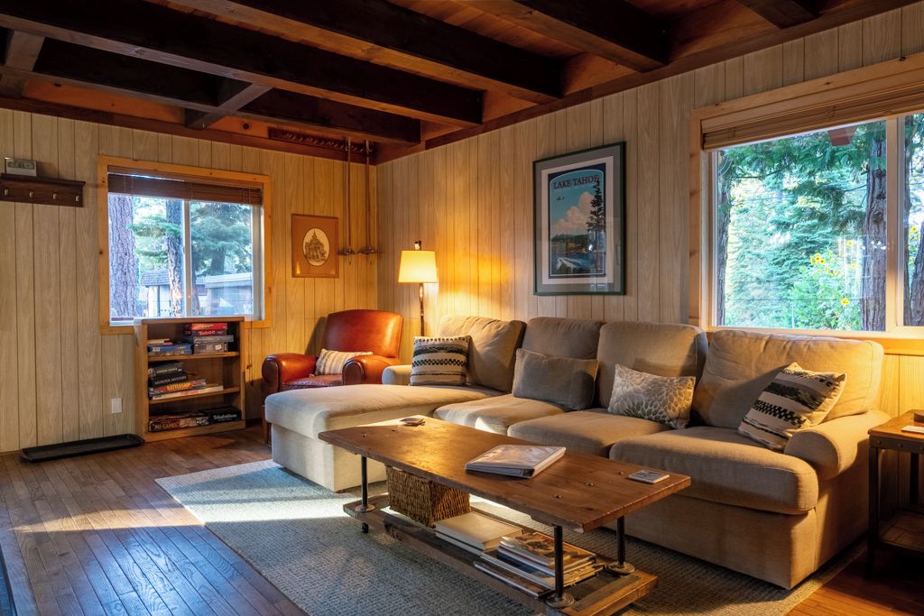 A cozy living room with a sofa, a coffee table, and a bookshelf.