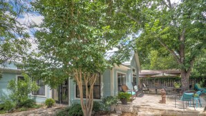 A house with a patio area featuring outdoor furniture and a fire pit. - 2 Blocks From Marketplatz & The Heart Of Main Street Shopping And Dining! (Fredericksburg)