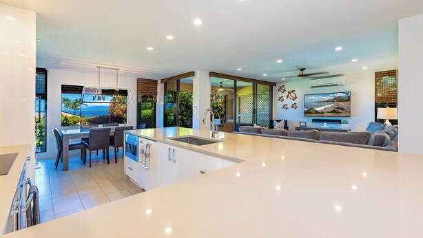 A modern kitchen with a central island, dining area, and a large living space with a view of the ocean. - Designer - Best View!Ground Flr 2 Bdm/2Bth 39c! Remaining Fall$400 (Kihei)