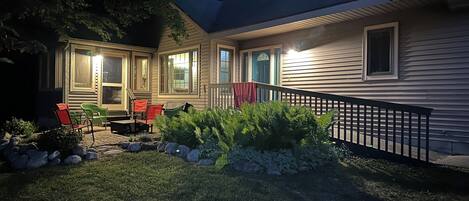 A house with a covered porch, outdoor seating, and a well-maintained garden.