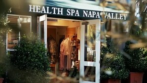 The entrance of a health spa with a visible storefront and clothing racks. - Walk to Restaurants, Wineries and More (Saint Helena)
