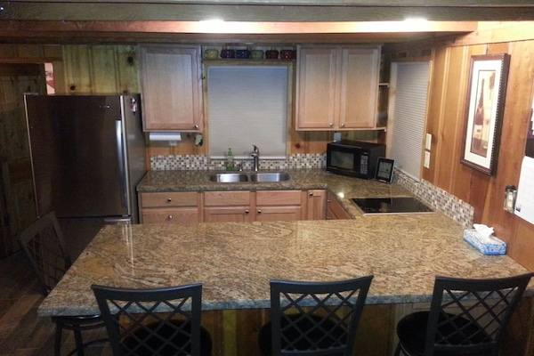 Stainless Steel, Granite Counter, Open Kitchen. Seating for 4 at counter.