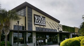 A Whole Foods store with a modern design, large windows, and a prominent sign.