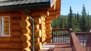 A wooden cabin with a balcony, log siding, and a metal roof. - King's Deer Lodge in Denali  (Denali)