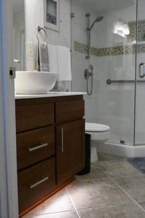 A bathroom with a white sink, a toilet, and a shower area. - Great Family Retreat w Amazing Views. #11D (Pensacola Beach)