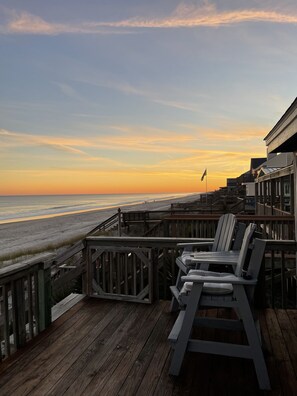 A wooden deck with lounge chairs overlooking a beach at sunset. - Beachfront 3 bedroom 2 bath pet friendly w/fee-Special rates on Winter weekends (Surf City)