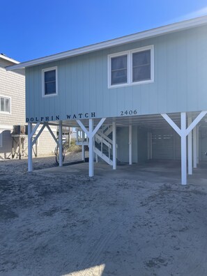 A two-story building with the name 'Dolphin Watch' and the number '2406' on the facade.