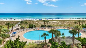 A resort with a large pool, beach access, and palm trees. - Beach Colony West 4A- Gulf-front 3 BD/3BA w/Beach Service & Sleeps up to 8 (Navarre Beach)
