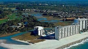 A coastal hotel with multiple high-rise buildings, a beach, and a river. - Oceanfront Condo, Gorgeous, Clean & Remodeled located at Sands Beach Club #325 (Myrtle Beach)