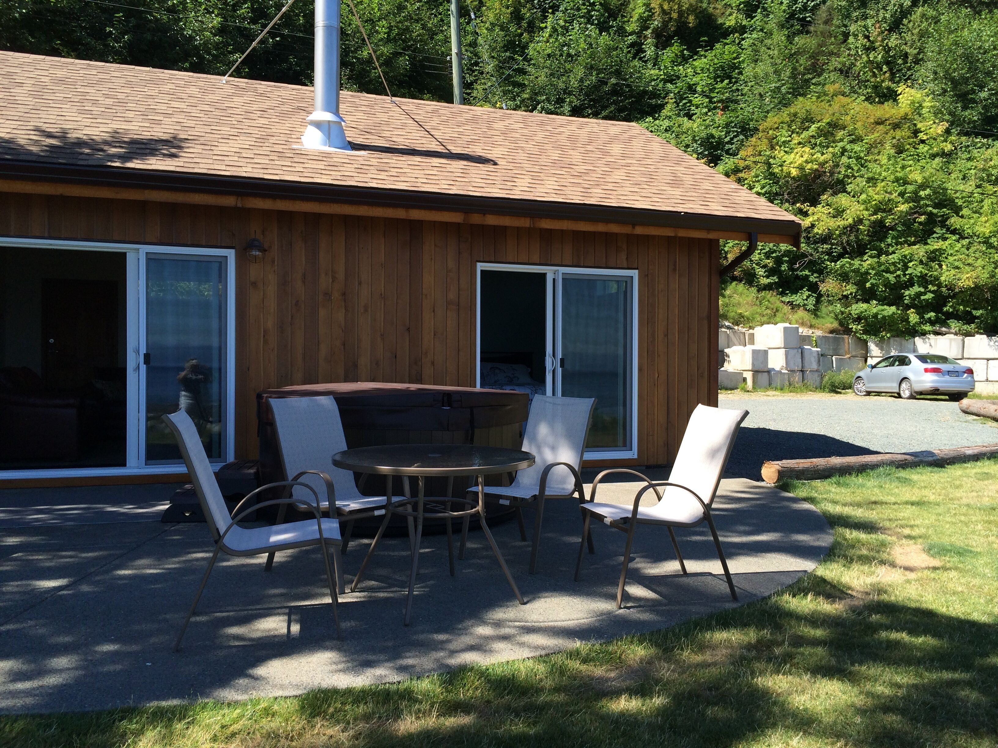 Ocean side of cottage with parking space to right