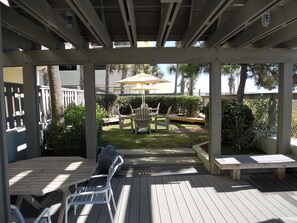 Relax in a serene outdoor space surrounded by lush greenery and a wooden fence, perfect for a peaceful retreat.