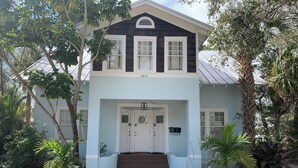 A two-story house with a front porch, a mailbox, and a 'Reserved Parking' sign.