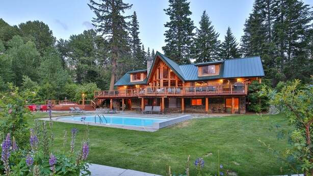 A log cabin with a pool, surrounded by a lush garden and tall trees. - Heaven Can Wait Lodge ~ Riverfront Estate on 12 Private Acres ~ Expansive Views (Leavenworth)