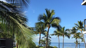 A pool area with lounge chairs, a small pool, and a view of the ocean. - Beautiful, Ocean Front Condo With An Ocean View In Sunny Kihei, Maui! (Kihei)