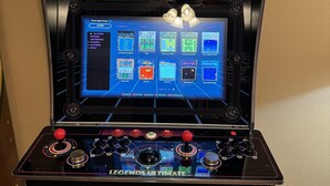 A video game arcade machine with a screen displaying various game options and a joystick control panel. - 8 Bedrooms, 12 beds, pool, hot tub,putting green, pool table, ping pong, bbq (Phoenix)